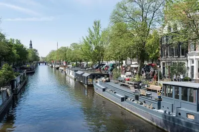 a canal with boats parked on the side of it at Luxury Houseboat-Apartment Lady Jane in Amsterdam
