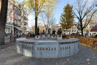a park with a statue in the middle of a city at Luxury Houseboat-Apartment Lady Jane in Amsterdam