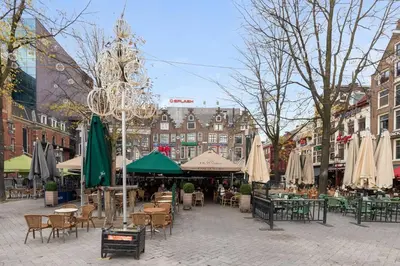 a city street with tables and chairs and umbrellas at Luxury Houseboat-Apartment Lady Jane in Amsterdam