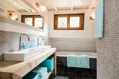 a bathroom with two sinks and a tub at Luxury large Houseboat AZARA in Amsterdam
