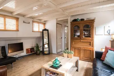 a living room with a couch and a table at Luxury large Houseboat AZARA in Amsterdam