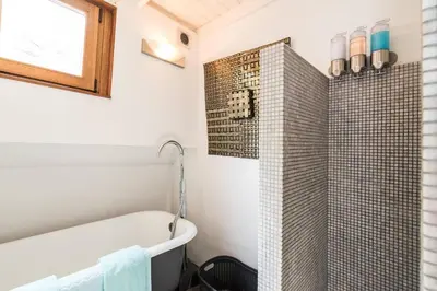 a bathroom with a bath tub and a shower at Luxury large Houseboat AZARA in Amsterdam