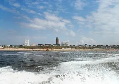 a body of water with a beach and a city at Appartement Seabird in Zandvoort