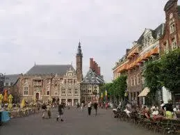 a group of people walking around a city street at Appartement Seabird in Zandvoort