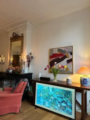 a living room with a tv and a couch at Canal view house - 17th century town house in Amsterdam