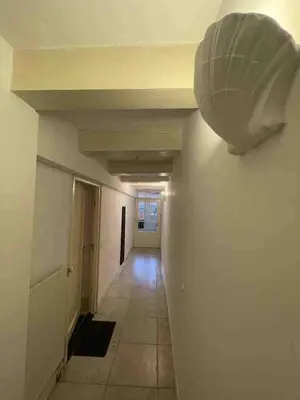 a hallway in a building with a light on the wall at Canal view house - 17th century town house in Amsterdam
