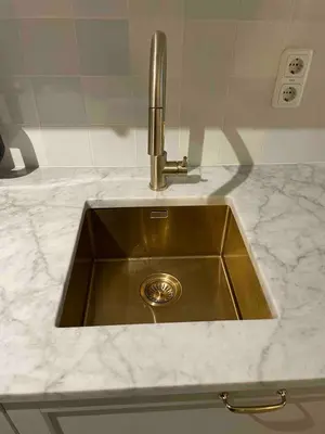 a kitchen sink with a faucet on a counter at Canal view house - 17th century town house in Amsterdam