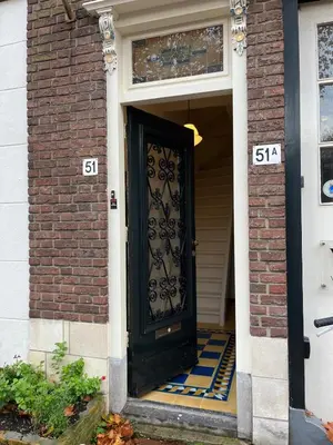 a black door on a brick house with at Characteristic Dutch home in historic center Gouda in Gouda