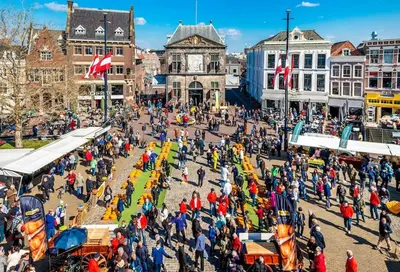 an overhead view of a crowd of people in a market at Characteristic Dutch home in historic center Gouda in Gouda
