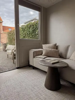 a living room with a couch and a table at C Studio Katwijk in Katwijk aan Zee