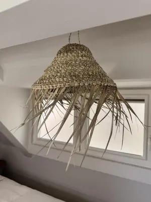 a chandelier hanging from the ceiling in a bedroom at C Studio Katwijk in Katwijk aan Zee