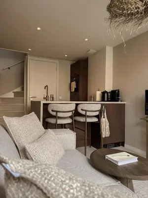a living room with a couch and a kitchen at C Studio Katwijk in Katwijk aan Zee