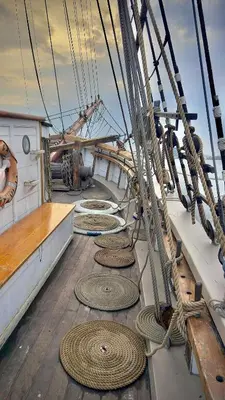 a boat with many ropes on the deck at The Vega 1909 - Historic Wooden Ship in Amsterdam