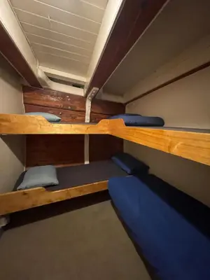 a room with two bunk beds in a boat at The Vega 1909 - Historic Wooden Ship in Amsterdam