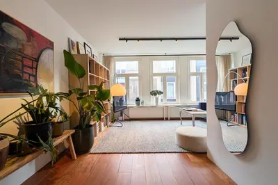 a living room filled with lots of potted plants at Charming Apartment with Roof Terrace in Amsterdam
