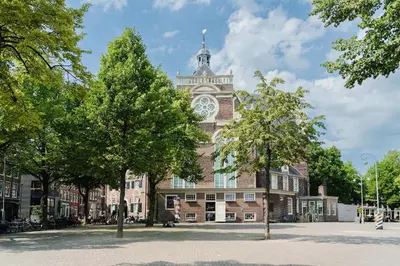 a building with a clock tower on top of it at Charming Apartment with Roof Terrace in Amsterdam