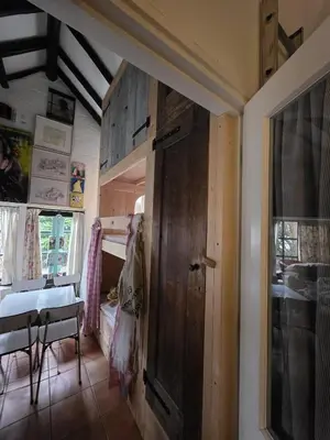 a room with a wooden door in a room with a table at Op Vakantie bij Nicole in Putten