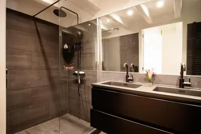 a bathroom with a sink and a shower at Canal view luxury apartment in the Jordaan in Amsterdam