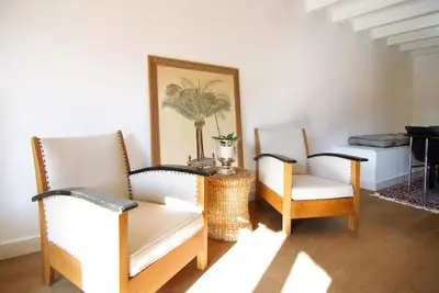 a living room with two chairs and a table at Canal view luxury apartment in the Jordaan in Amsterdam