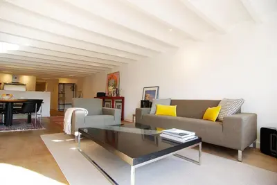 a living room with a couch and a table at Canal view luxury apartment in the Jordaan in Amsterdam