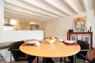 a dining room with a wooden table and chairs at Canal view luxury apartment in the Jordaan in Amsterdam