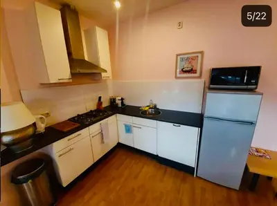 a small kitchen with a refrigerator and a sink at Lovely Apartment Wassenaar 6P in Wassenaar