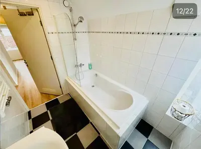 a bathroom with a bath tub and a toilet at Lovely Apartment Wassenaar 6P in Wassenaar