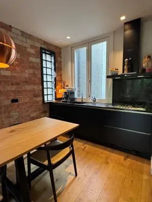 a kitchen with a table and a fish tank at The Park Loft in Amsterdam