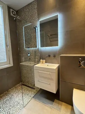 a bathroom with a shower and a sink and a mirror at The Park Loft in Amsterdam