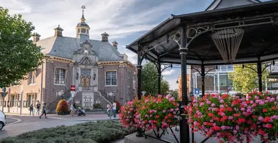 a building with a bunch of flowers in front of it at Palm Beach apartments in Zandvoort