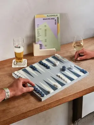 a bottle of beer and a glass of wine on a table at CityHub Amsterdam in Amsterdam