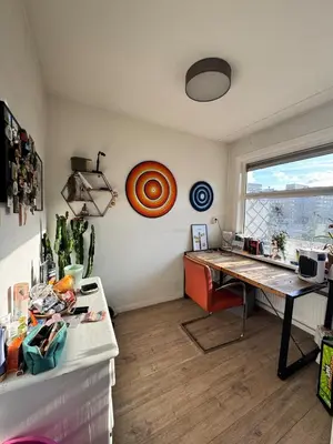 an office with a desk and a table in a room at Cozy & Sunny apartment in Amsterdam west in Amsterdam