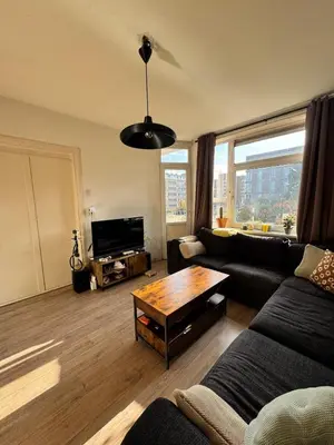 a living room with a couch and a table at Cozy & Sunny apartment in Amsterdam west in Amsterdam