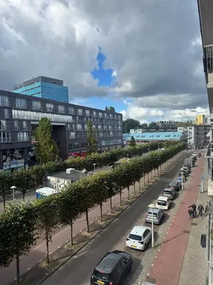 a row of cars parked on a city street at Cozy & Sunny apartment in Amsterdam west in Amsterdam
