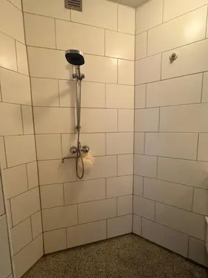 a bathroom with a shower with white tiled walls at Cozy & Sunny apartment in Amsterdam west in Amsterdam