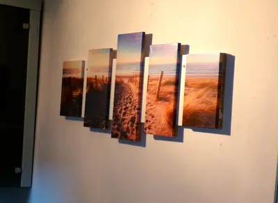 a group of pictures hanging on a wall at Beach Quarter in Ons Belang