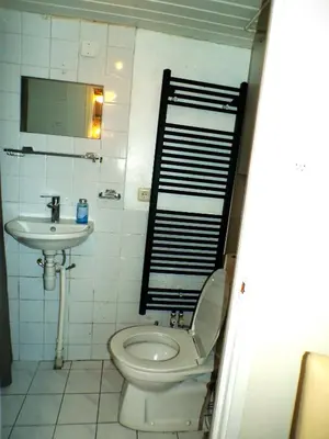 a bathroom with a toilet and a sink at Beach Quarter in Ons Belang