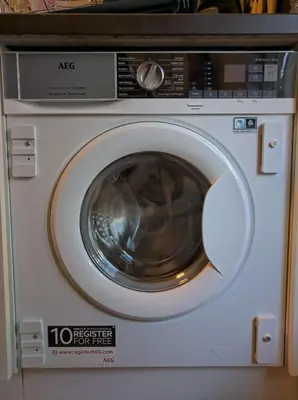 a white washing machine with its door open at Apartment in Museumplein in Amsterdam