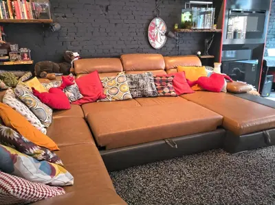 a brown couch with colorful pillows on it at Apartment in Museumplein in Amsterdam