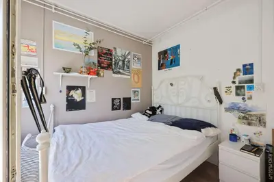 a bedroom with a white bed with a white headboard at Cozy place many rooms in Amsterdam