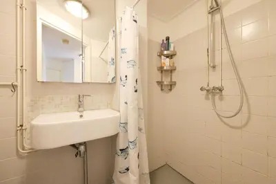 a bathroom with a sink and a shower at Cozy place many rooms in Amsterdam