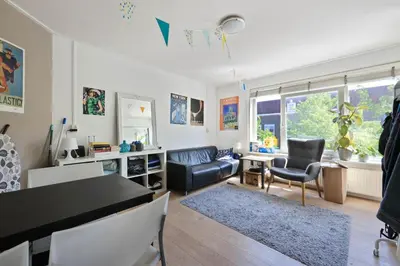 a living room with a couch and a table at Cozy place many rooms in Amsterdam