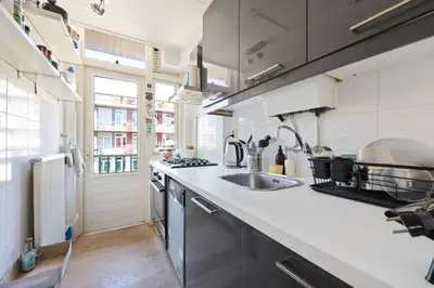 a kitchen with a sink and a counter top at Cozy place many rooms in Amsterdam