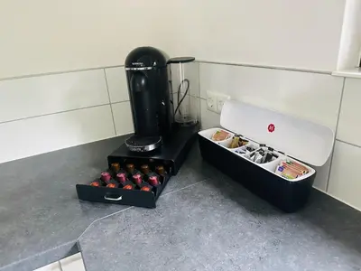 a kitchen with a stove and a box ofocolates at Stylish chalet in nature near Amsterdam in Halfweg