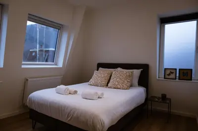 a bedroom with a bed with two stuffed animals on it at Klein Witje in Haarlem