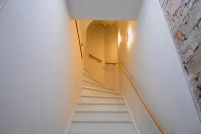 a staircase in a room with white walls and ceilings at Klein Witje in Haarlem