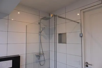 a shower with a glass door in a bathroom at Klein Witje in Haarlem