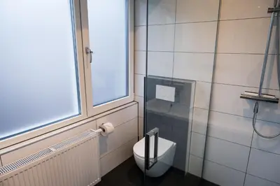 a bathroom with a toilet and a window at Klein Witje in Haarlem