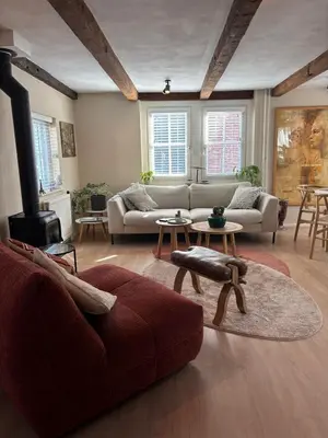 a living room with a couch and a table at Vissershuisje Achterom 4 in Zandvoort