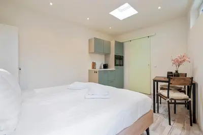 a bedroom with a bed and a table and a chair at Studio Elysium in Zandvoort